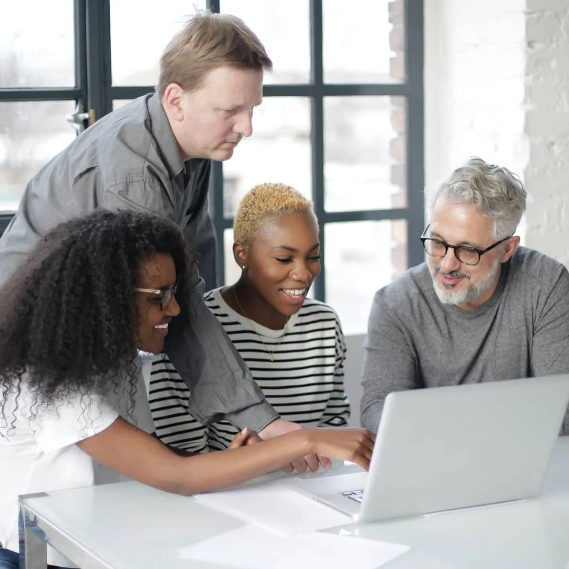 Team collaborating on a laptop